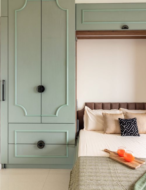 Minimalist bedroom with a muted green wardrobe