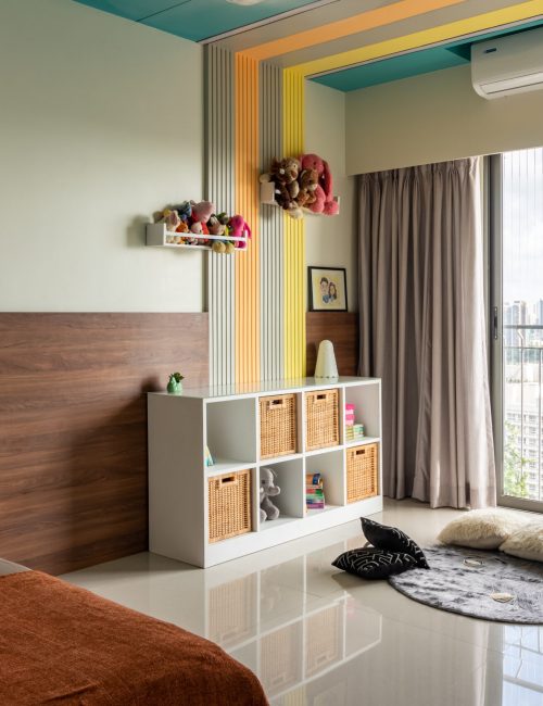Vibrant kids' bedroom with colorful striped wall accents